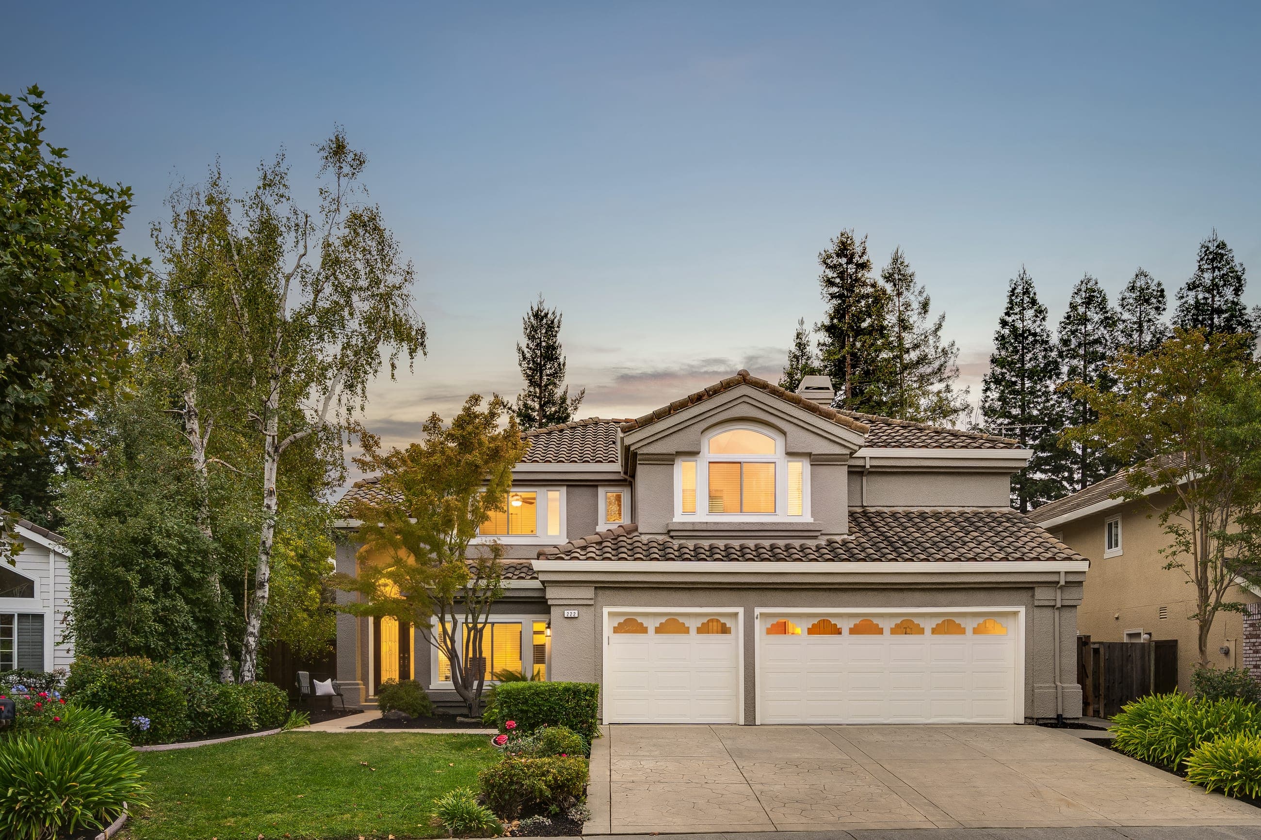 222 Viewpoint Drive at dusk: the two-story home with lit windows behind a landscaped front yard.
