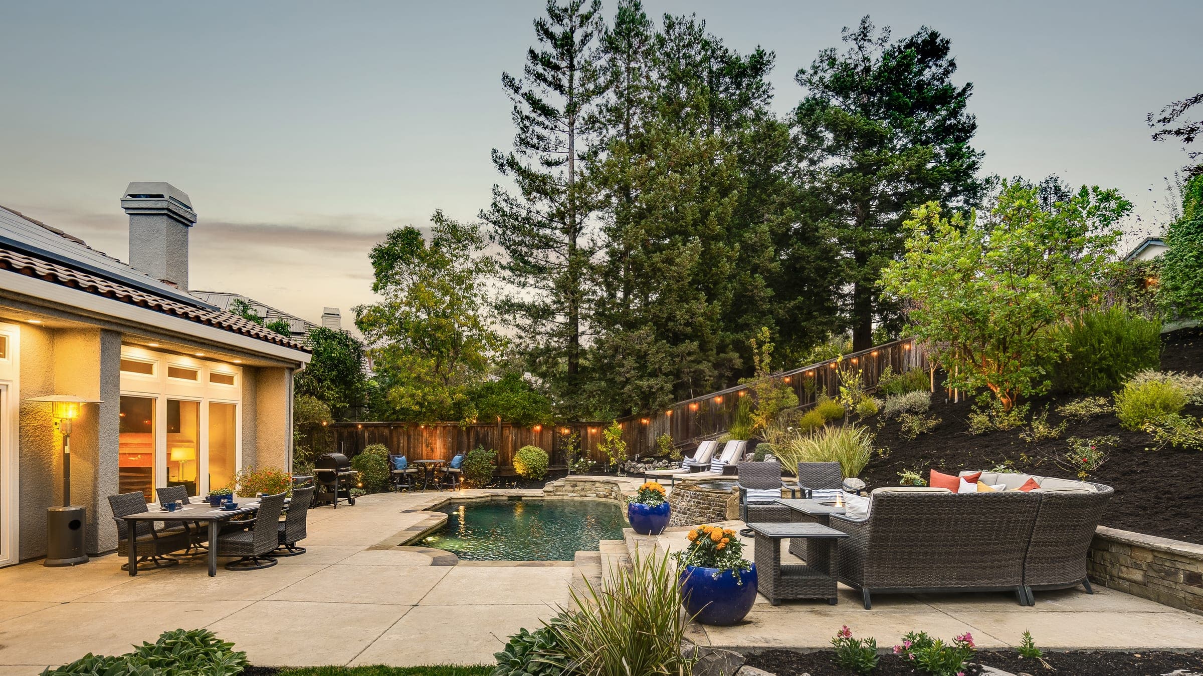 The patio, pool, and lounge at dusk